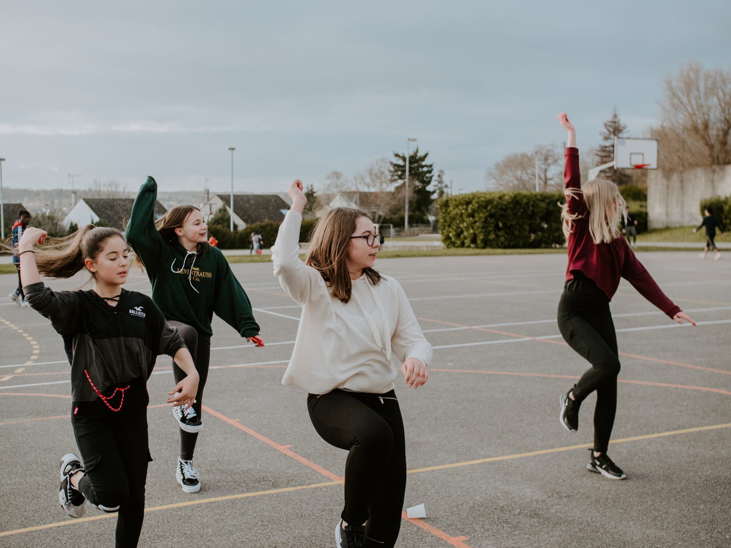 Four girls dancings on the playground